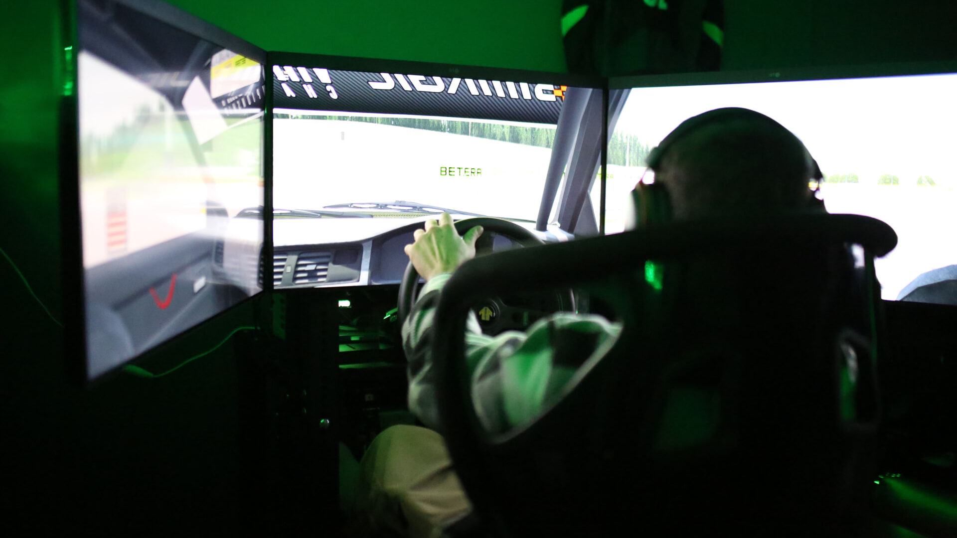 Driver at a Forma Simdrift simulator rig mid-session